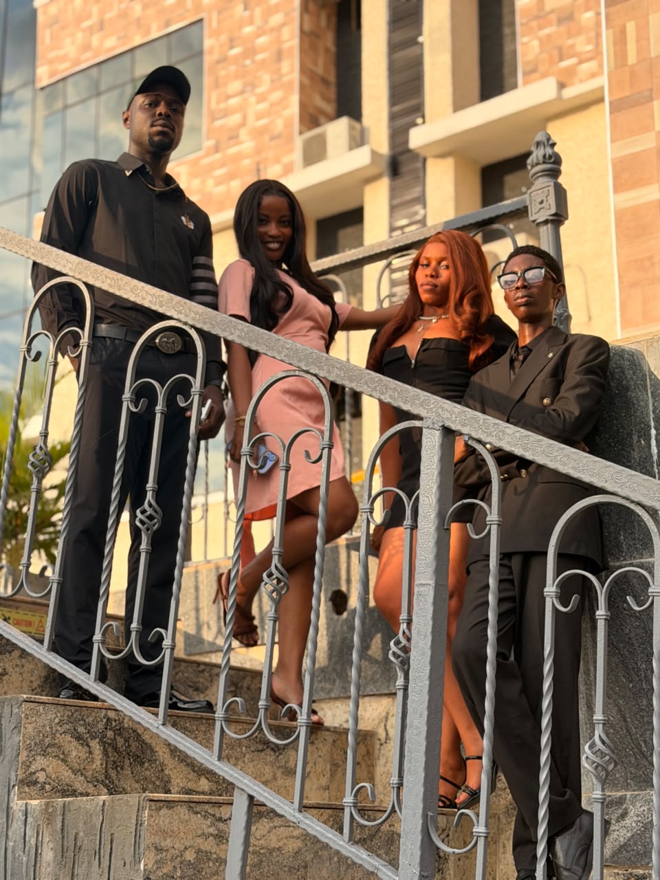 Cast grouped together on a staircase