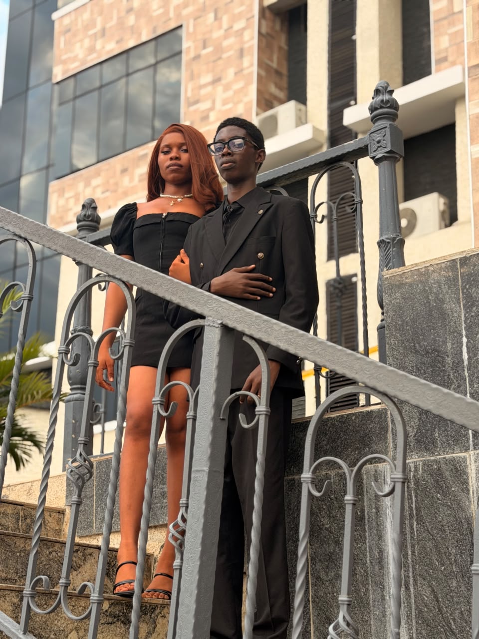 Two cast members on a stairway